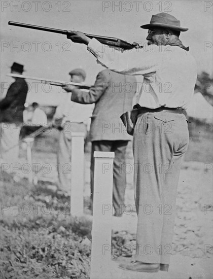 Composer and conductor John Philip Sousa, shooting a gun ca. 1910-1915