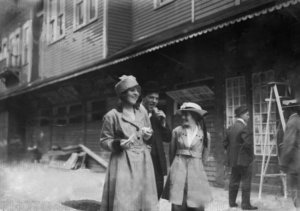 Coney Island vistors eating a hot dog ca. 1915