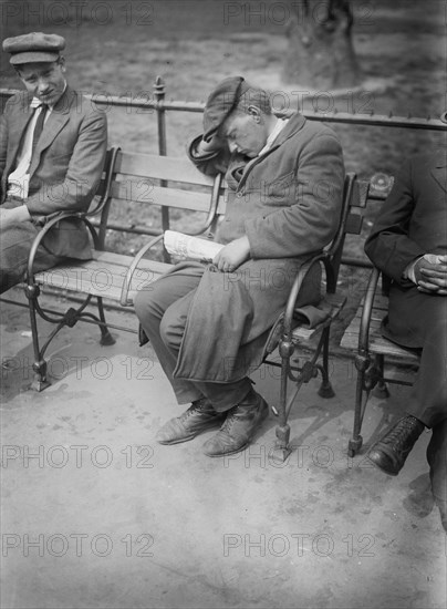 Man sleeping on a park bench in Union Square ca. 1910-1915
