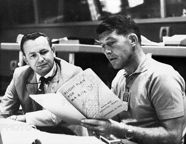 (19 Sept. 1962) Astronaut Walter M. Schirra Jr, (right), Mercury-Atlas 8 (MA-8) pilot, discusses the MA-8 flight plan with flight director Christopher C. Kraft Jr., Chief of the Flight Operations Division at the Manned Spacecraft Center, Houston