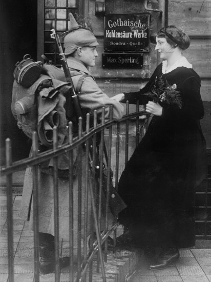 German soldier saying goodbye to a woman, in front of the Gotha Carbonic Acid Plant, during World War I ca. 1915