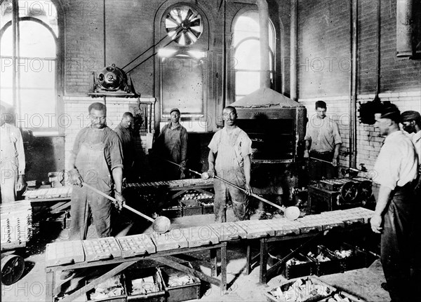 Men pouring melted metal into molds in the Government Printing Office, Washington, D.C. ca. 1909-1932