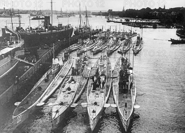 German submarines in a harbor. Front row (left to right): U-22, U-20 (sank the Lusitania), U-19 and U-21. Back row (left to right): U-14, U-10 and U-12 ca. 1914-1915