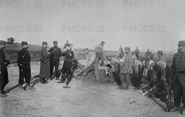 German prisoners burying dead soldiers, near Reims, France during World War I ca. October 1914