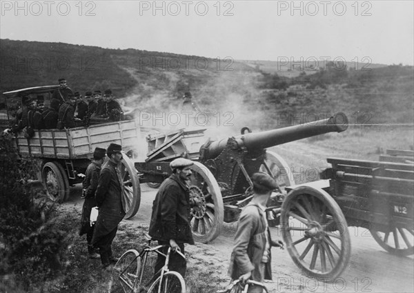 French soldiers in motor tractor which is pulling a large gun along the road at the beginning of World War I ca. 1914-1915