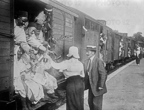 People giving wine to Algerian soldiers at Champigny-sur-Marne, France, during World War I ca. 1914-1915