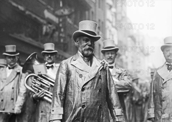 Composer and conductor John Philip Sousa in front of a marching band ca. May 1914