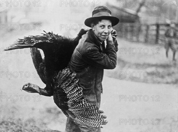 A man carrying home his Thanksgiving turkey ca. 1910-1915