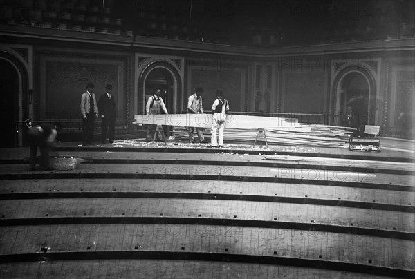 Workers tearing up the floor in the House of Representatives in the U.S. Capitol ca. 1910-1915