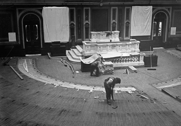 Workers tearing up the floor in the House of Representatives in the U.S. Capitol ca. 1910-1915