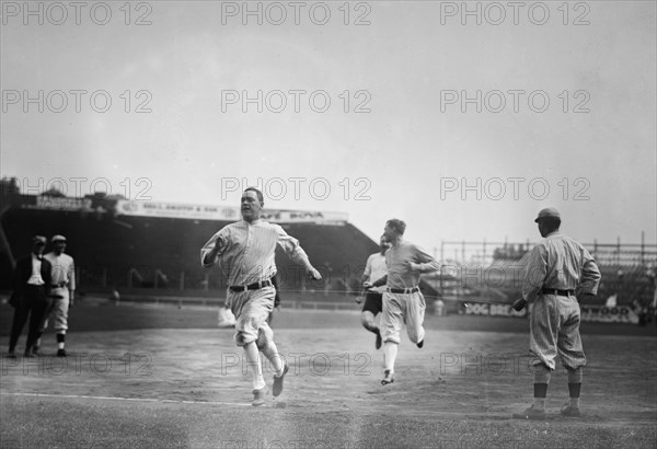 Hick Cady of Boston Red Sox wins foot race with Jack O'Brien (Boston Red Sox trainer, pin shorts, partially obscured) and teammate Buck O'Brien (looking to his right) at Fenway Park, Boston (baseball) ca. September 25, 1912