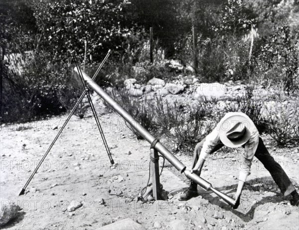 Dr. Robert H. Goddard loading a 1918 version of the Bazooka of World War II.
