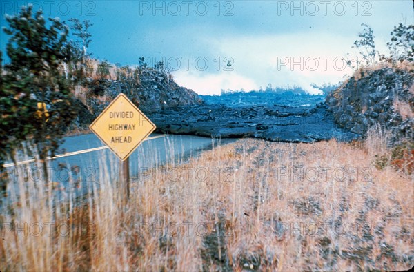 This is a photo from June 1969 during the Mauna Ulu eruption of Kilauea Volcano of lava flow across the road in the Hawaii Volcanoes National Park.