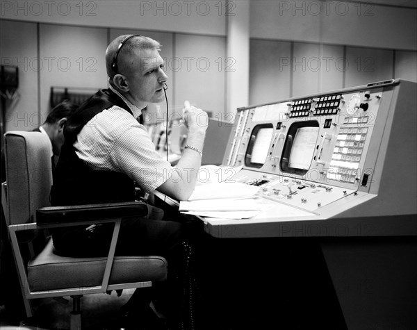 (April 1965) Prior to the Gemini-Titan 4 mission, flight director Eugene F. Kranz is pictured during a simulation at the Flight Director console in Houston's Mission Control Center on the Manned Spacecraft Center site.