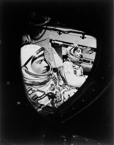 (23 March 1965) This view of astronauts John W. Young (left), pilot, and Virgil I. Grissom, command pilot, was taken through the window of the open hatch on Young's side of the Gemini-Titan 3 spacecraft