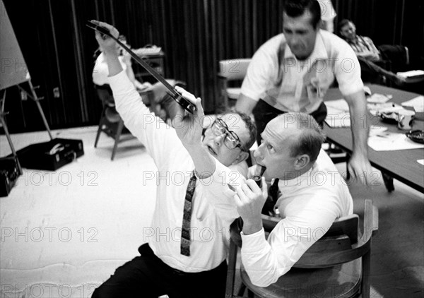 (23 Sept. 1966) Astronauts Charles Conrad Jr. (with pipe) and Richard F. Gordon Jr. (background) view negatives from their Gemini-11 mission.