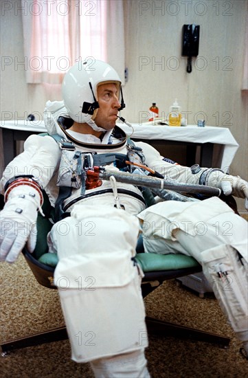 (4 Dec. 1965) Gemini-7 pilot James A. Lovell Jr. has a temperature check with an oral temperature probe attached to his spacesuit during a final preflight preparations for the Gemini-7 space mission.