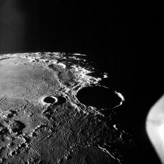 20 Jul 1969 - Apollo 11 oblique view of large crater Theophilus located at the NW edge of the Sea of Nectar on the lunar nearside. Theophilus about 60 statute miles in diameter. The smooth area is Mare Nectaris