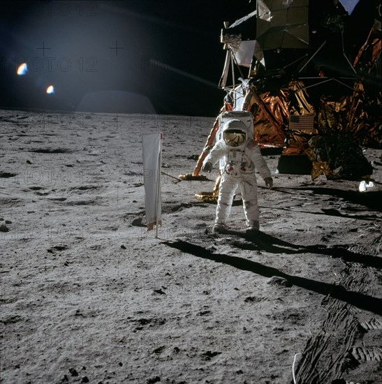 (20 July 1969) Astronaut Edwin E. Aldrin Jr., lunar module pilot, is photographed during the Apollo 11 extravehicular activity (EVA) on the lunar surface. In the right background is the lunar module.