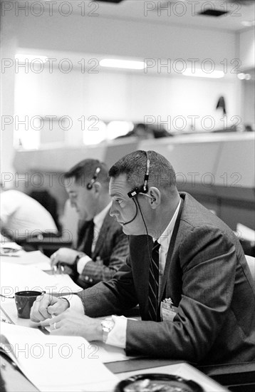 Astronaut Clifton C. Williams is shown at console in the Mission Control Center (MCC) in Houston, Texas during the Gemini-Titan 3 flight.