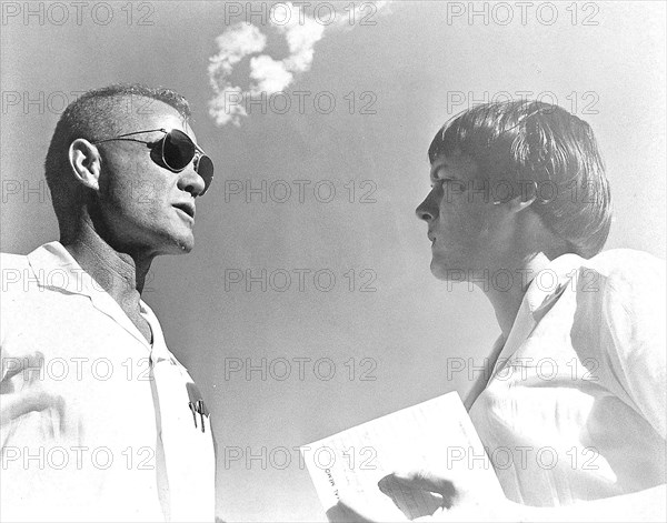 (1962) Astronaut John H. Glenn Jr., pilot of the Mercury-Atlas 6 (MA-6) Earth-orbital space mission, confers with astronaut nurse Dolores B. O'Hara, R.N., during MA-6 prelaunch preparations.