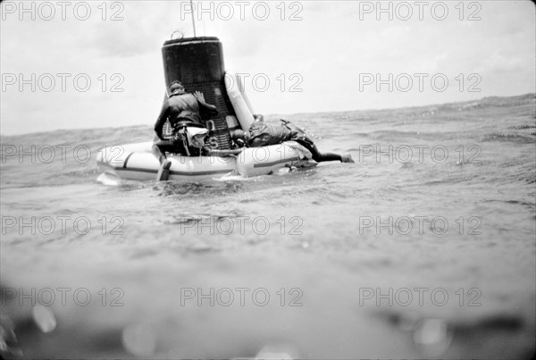 (16 May 1963) A U.S. Navy frogman team attaches a flotation collar to the Mercury-Atlas 9 (MA-9)'Faith 7' spacecraft during recovery operations in the central Pacific near Midway Island.