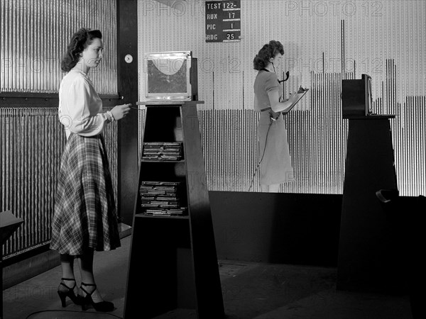 Female computers at the National Advisory Committee for Aeronautics (NACA) Lewis Flight Propulsion Laboratory copy pressure readings from rows of manometers below the 18- by 18-inch Supersonic Wind Tunnel. ca. 1949