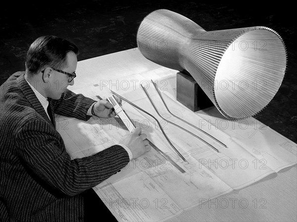 NASA Engineer Examines the Design of a Regeneratively-Cooled Rocket Engine ca. 1958