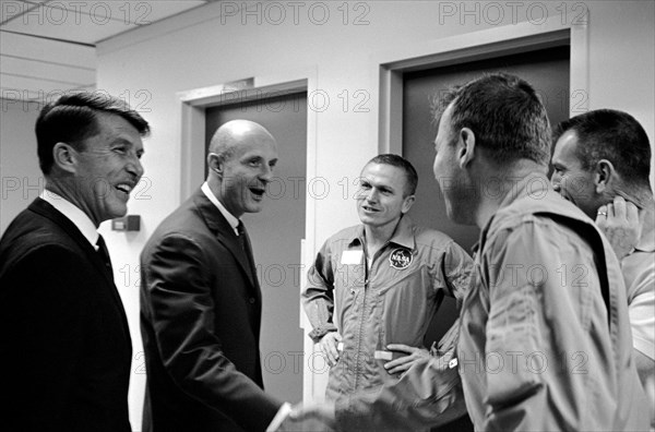 (19 Dec. 1965) This happy round of handshakes took place in the Manned Spacecraft Operations Building crew quarters, Merritt Island, as the Gemini-6 crew (left) welcomed the Gemini-7 crew back to the Kennedy Space Center.