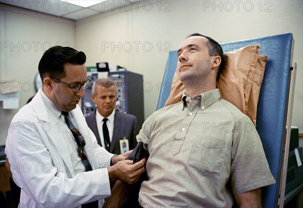 (1 June 1965) Dr. Charles A. Berry, chief of Center Medical Programs, MSC, Houston, Texas, prepares to check the blood pressure of astronaut James A. McDivitt, command pilot for the Gemini-Titan 4 spaceflight.