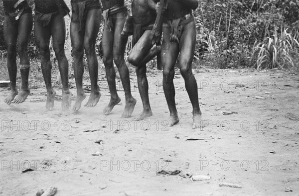Papuans armed with guns do a war dance; Date November 10, 1947; Location Indonesia, Dutch East Indies