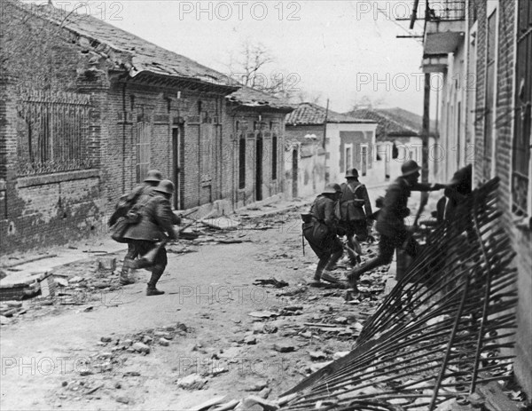 Nationalist soldiers raiding a suburb of Madrid during the Spanish Civil War ca. 1937