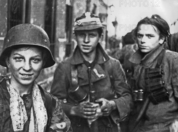Warsaw Uprising: Soldiers from the "Radoslaw Regiment" after several hours marching through sewers from Krasinski Square to Warecka Street in the Sródmiescie district, early morning on September 2, 1944. The boy in helmet is Tadeusz "Maszynka" Rajszc