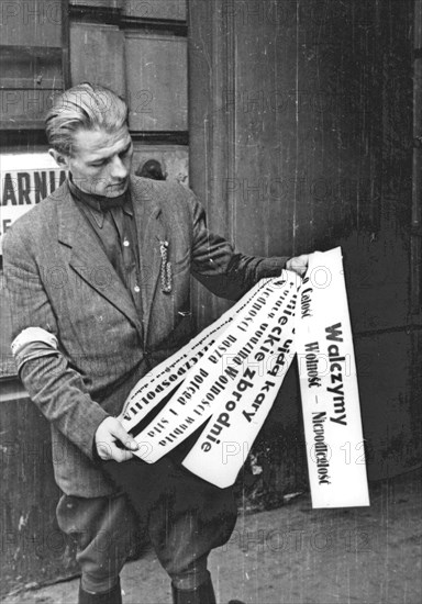 Warsaw Uprising: Insurgent posters presented by Roman Rozmilowski "Zawada", from "Koszta" Company, in front of print-shop "Stoleczna" at Moniuszki 11 Street ca. August 1944