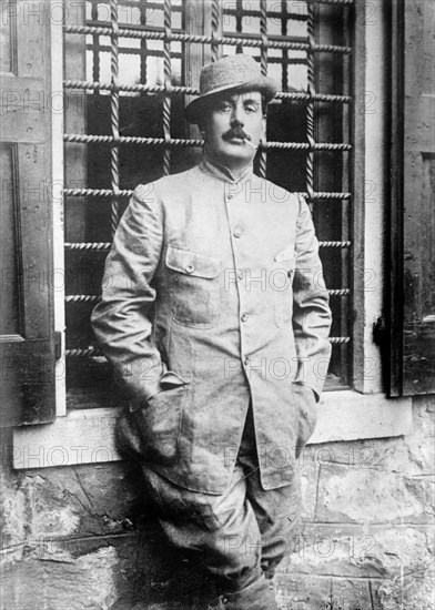 Giacomo Puccini in jacket, smoking cigarette