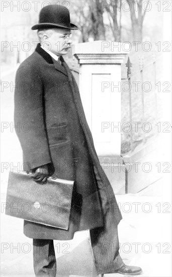 George B. Cortelyou carrying briefcase