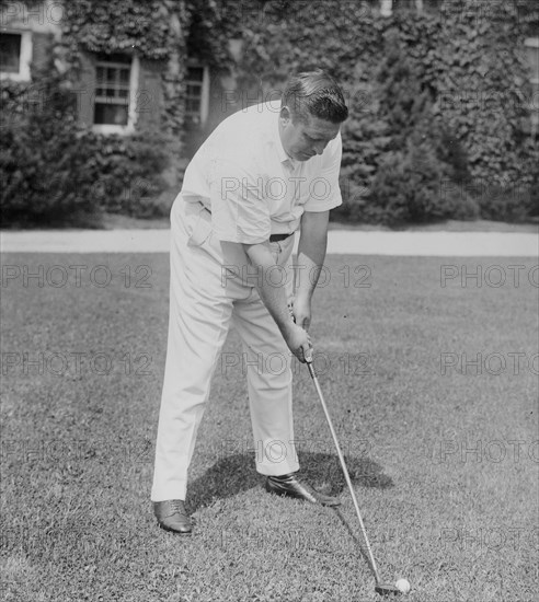 Photograph shows Irish American tenor singer John McCormack (1884-1945) with golf club