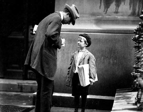 Michael Mc Nelis. This boy has just recovered from his second attack of pneumonia. Was found selling papers in a big rain storm today. Philadelphia, Pa, June 1910