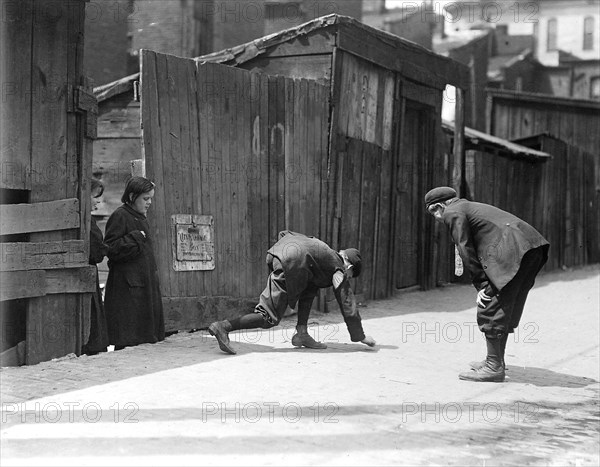 Truants, Red St. Clair, and chum shooting craps in front of Murphy's Branch at 1100 A.M. a school day, May 1910