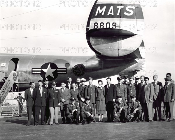 Vice President Richard Nixon, Pat Nixon, and flight crew stand in front of a military transport aircraft in Tripoli, Libya ca. 1953