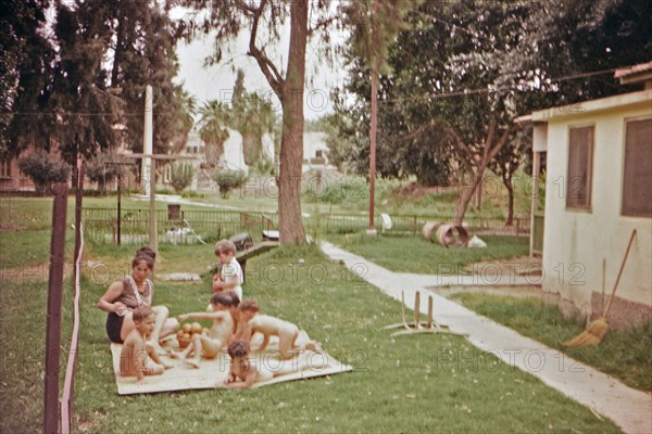 Israel April 1965:  Woman caretaker looking after toddlers outside at an Israeli Kibbutz