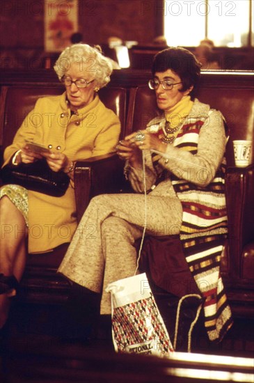 Amtrak train passengers pass the time before boarding at the Los Angeles Union Passenger Terminal, May 1974.