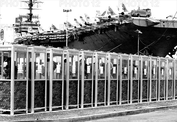 Sailors use some of the telephone booths