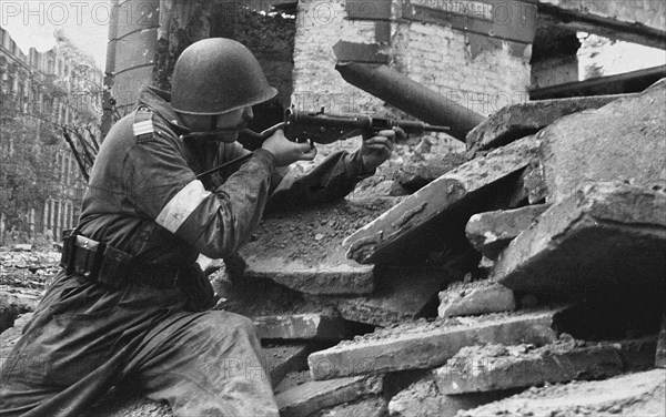 Warsaw Uprising in Poland, 1944. Polish Home Army soldier from battalion OW – KB „Sokól” on the na barricade Bracka street (9-12) near Nowogrodzka street ca. 1944