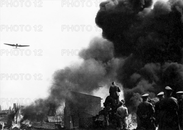 German forces enter Warsaw in late September 1939 (according to notes that come with the print), or Germans during Warsaw Uprising (according to research)