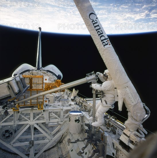Onboard Space Shuttle Columbia's (STS-87) first ever Extravehicular Activity (EVA), astronaut Takao Doi works with a 156-pound crane carried onboard for the first time ca. 1997