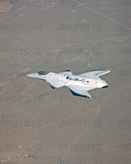 The tailless X-36 technology demonstrator research aircraft cruises over the California desert at low altitude during a 1997 research flight