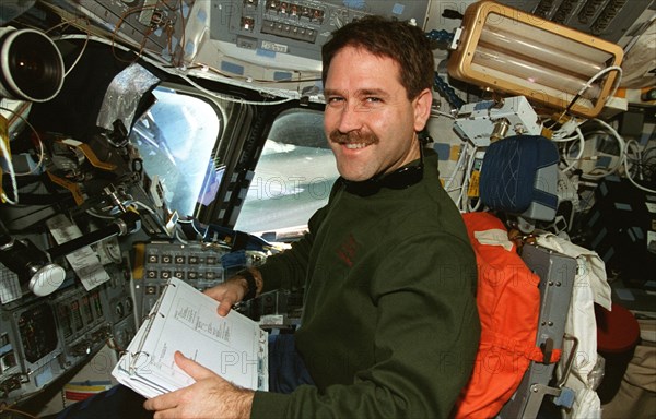 MS Grunsfeld at pilot's station on forward flight deck