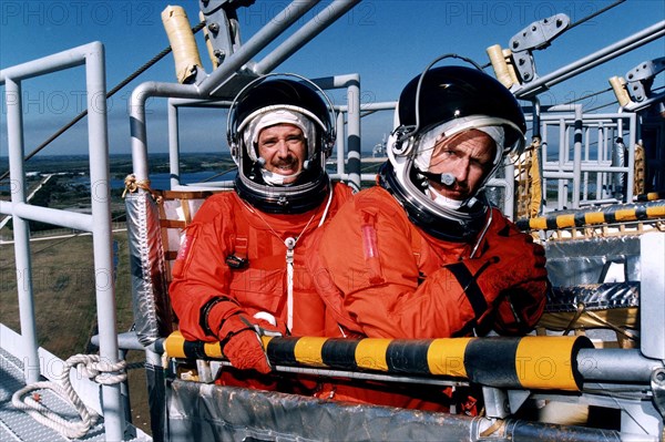 STS-82 Mission Commander Kenneth D. Bowersox, at right, and Pilot Scott J. "Doc" Horowitz practice emergency egress procedures in a slidewire basket at Launch Pad 39A