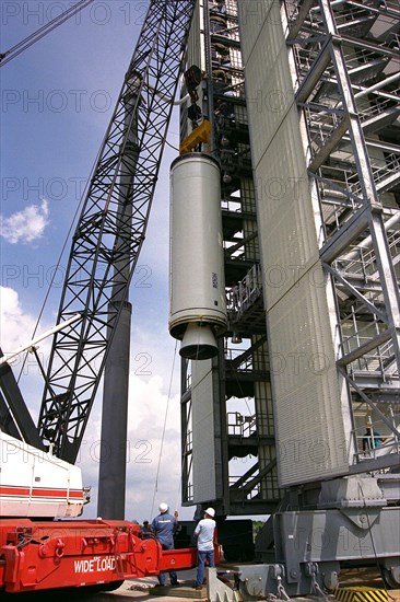 Workers erect the first stage of a Lockheed Martin Launch Vehicle-2 (LMLV-2) at Launch Complex 46 at Cape Canaveral Air Station ca. 1997